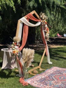 Decorated arch way with flowers and rug